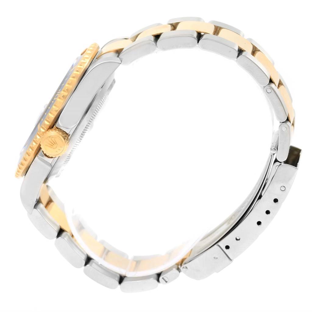 The image shows a side view of a Rolex Submariner 16613 Men's Steel and Gold (two tone) Blue Dial 16613 Men's Steel and Gold (two tone) Blue Dial watch, highlighting the crown, case, and two-tone bracelet.