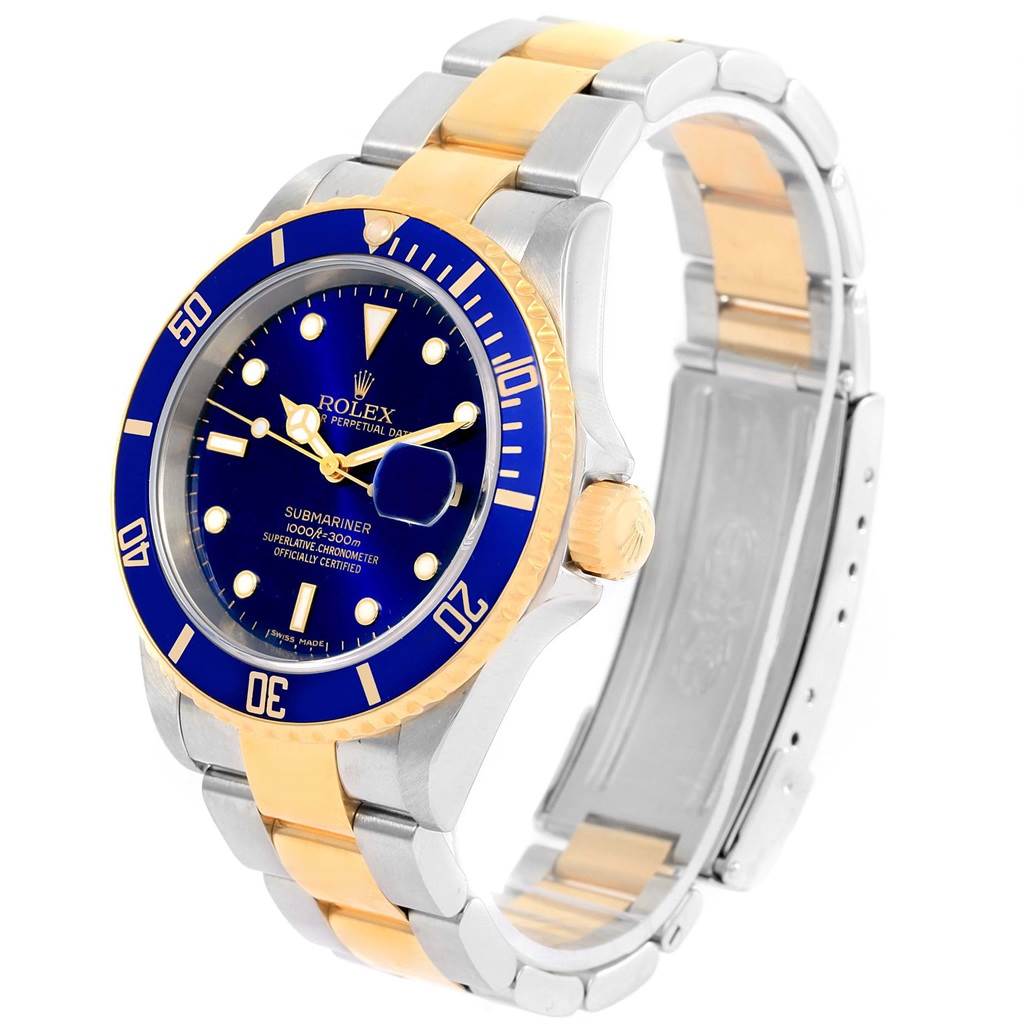 The image shows a Rolex Submariner 16613 Men's Steel and Gold (two tone) Blue Dial 16613 Men's Steel and Gold (two tone) Blue Dial watch at a three-quarter angle, highlighting its blue dial, bezel, and two-tone bracelet.