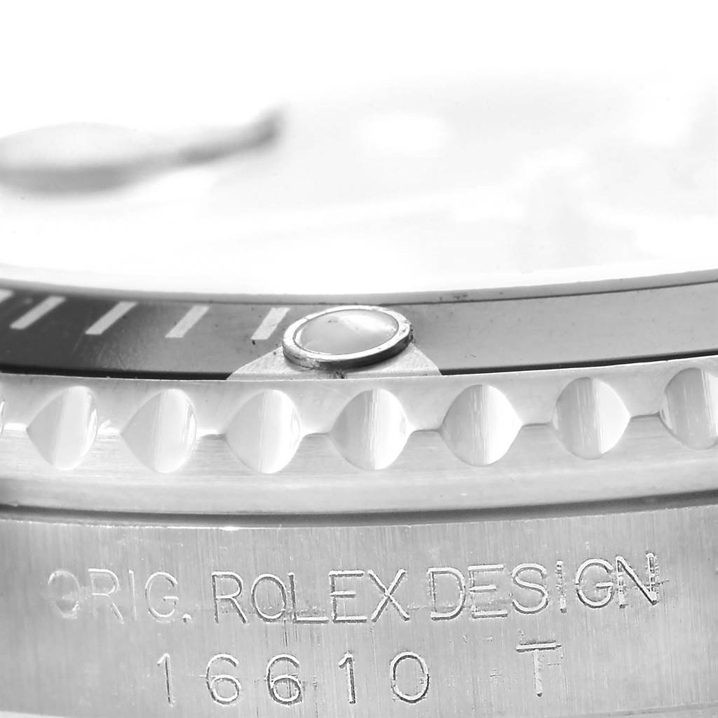 Close-up of the Rolex Submariner 16610 Men's Stainless Steel Black Dial 16610 Men's Stainless Steel Black Dial's case side, featuring the engraved model number and part of the bezel.
