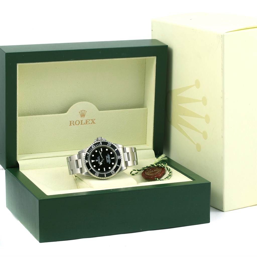 The image shows a Rolex Submariner 14060 Men's Stainless Steel Black Dial 14060 Men's Stainless Steel Black Dial watch in its open green and cream display box at a front-facing angle.