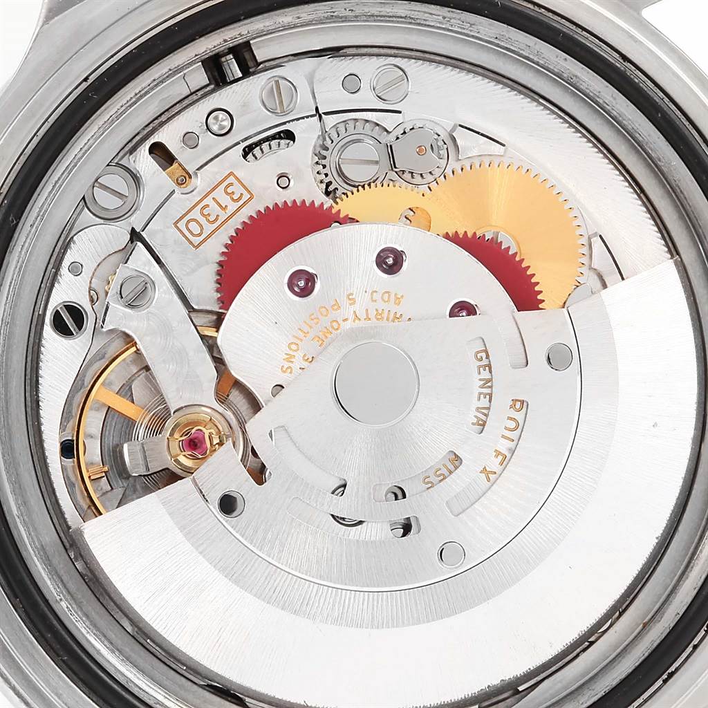 This image shows the movement of a Rolex Submariner 14060 Men's Stainless Steel Black Dial 14060 Men's Stainless Steel Black Dial watch from a back angle, revealing internal gears and components.