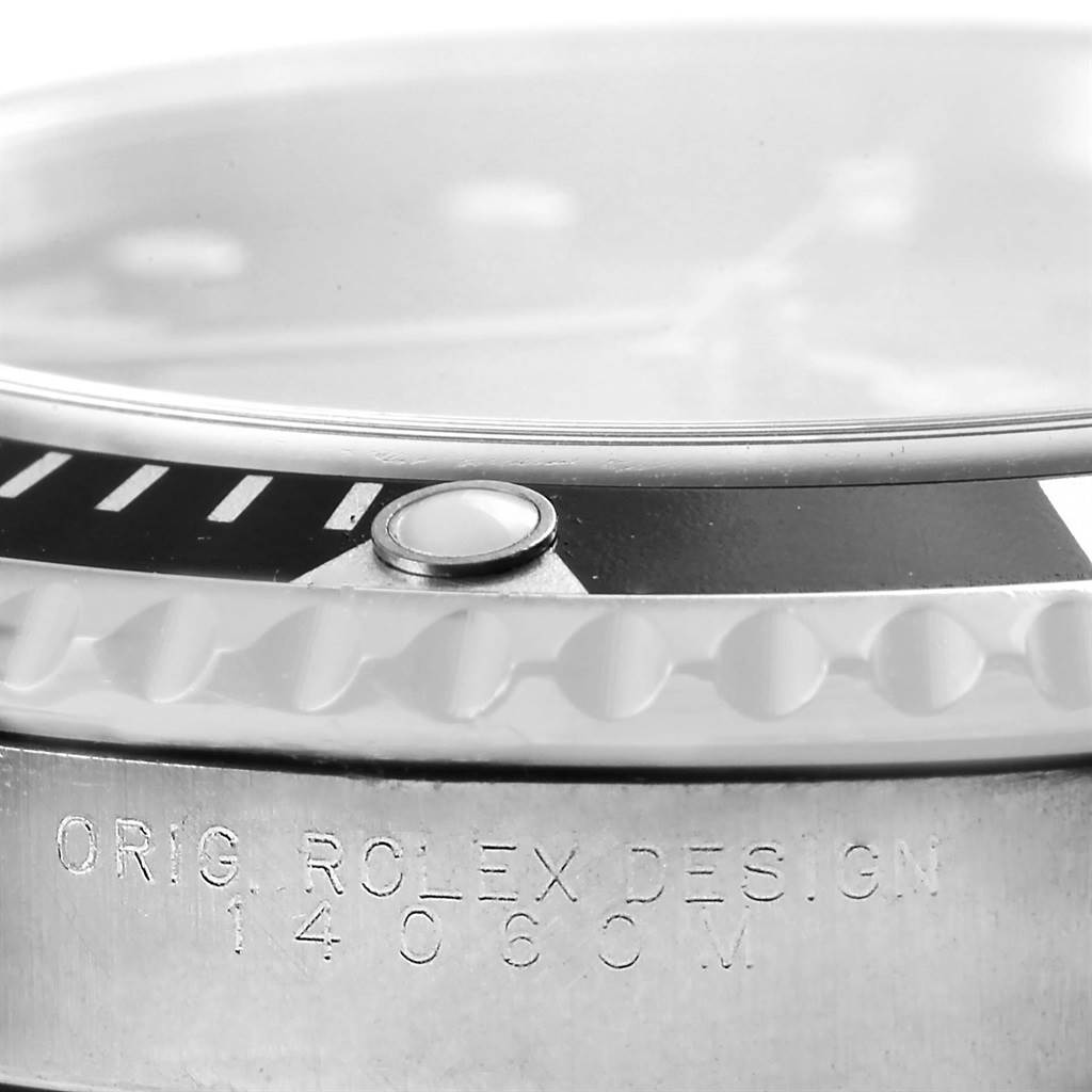 This close-up image shows the bezel, crystal, and engraved case side with "ORIG. ROLEX DESIGN" on a Rolex Submariner 14060 Men's Stainless Steel Black Dial 14060 Men's Stainless Steel Black Dial watch.