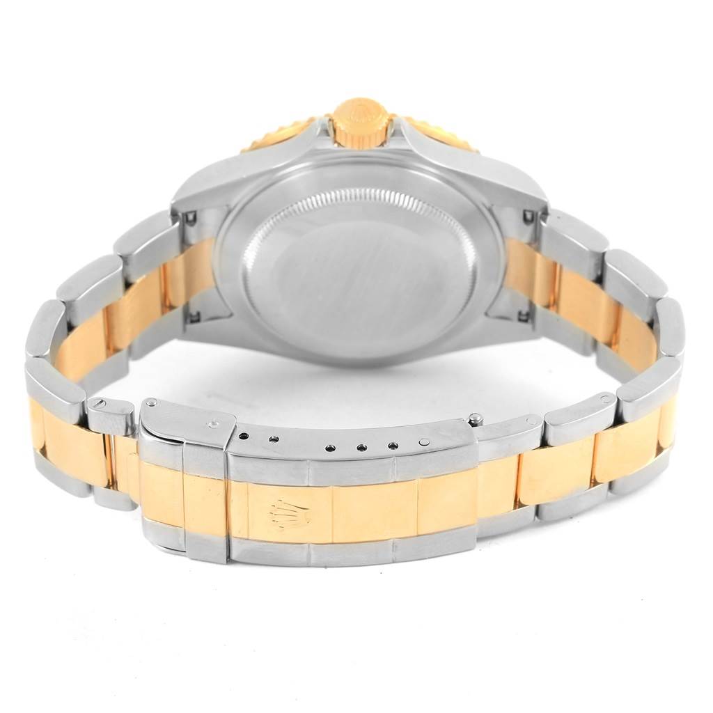 This image shows the back and clasp of a Rolex Submariner 16613 Men's Steel and Gold (two tone) Blue Dial 16613 Men's Steel and Gold (two tone) Blue Dial watch, highlighting the two-tone bracelet and the screw-down case back.