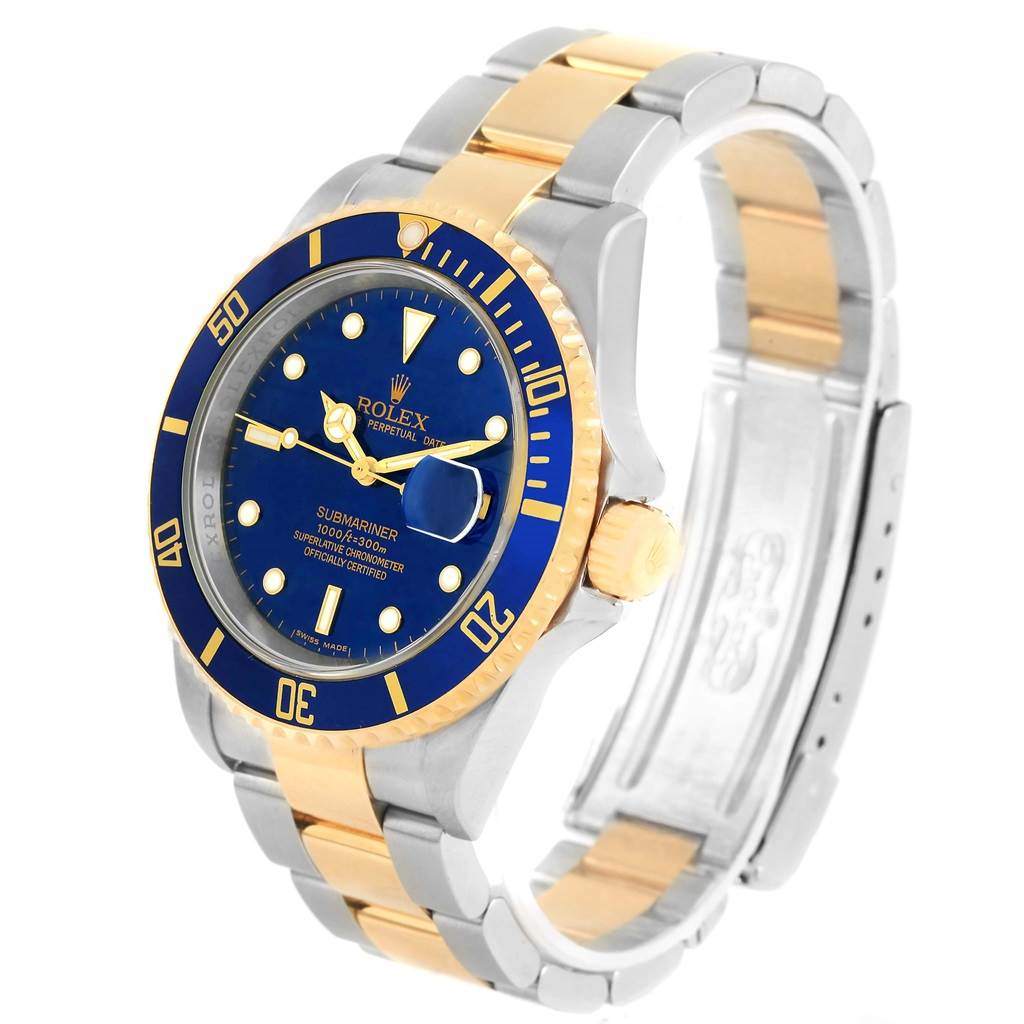 The image shows a Rolex Submariner 16613 Men's Steel and Gold (two tone) Blue Dial 16613 Men's Steel and Gold (two tone) Blue Dial watch at a three-quarter angle, featuring its blue dial, gold and silver bracelet, and rotating bezel.