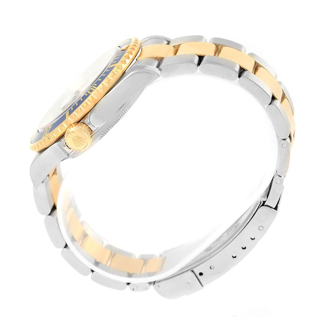 This image shows a side view of the Rolex Submariner 16613 Men's Steel and Gold (two tone) Blue Dial 16613 Men's Steel and Gold (two tone) Blue Dial watch, highlighting the two-tone metal bracelet and the crown and bezel.