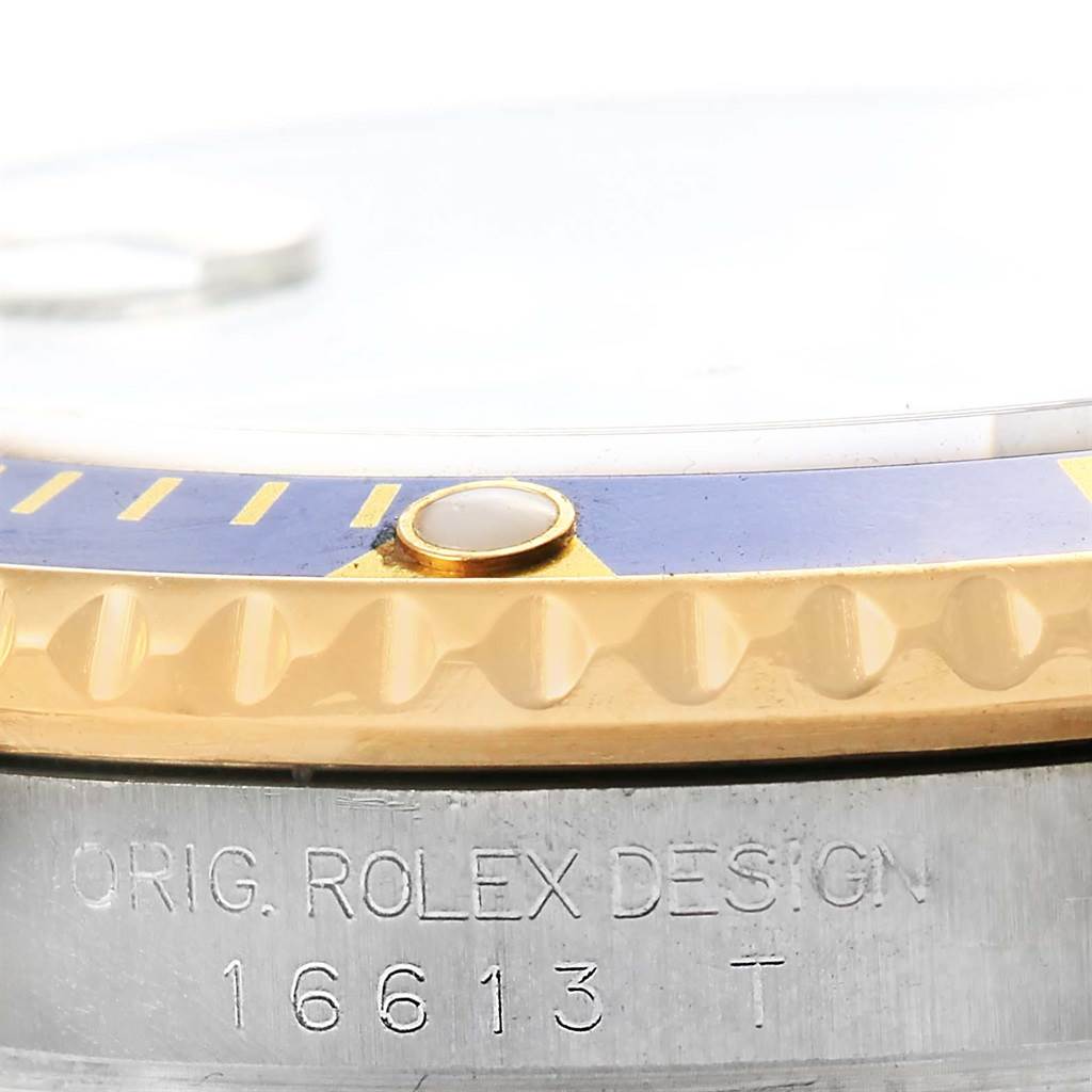 Close-up of the Rolex Submariner 16613 Men's Steel and Gold (two tone) Blue Dial 16613 Men's Steel and Gold (two tone) Blue Dial's bezel and case, showing the model number engraved on the side.