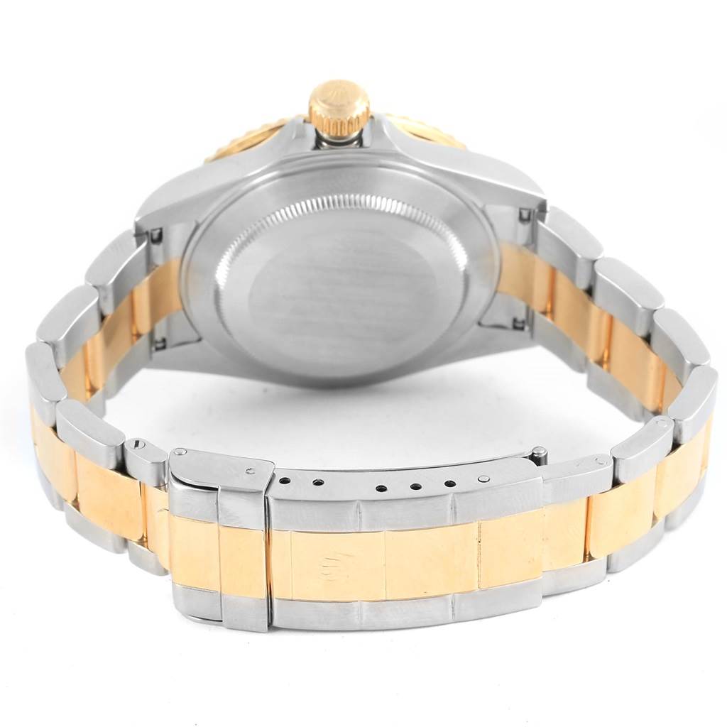 This image shows the back case and bracelet of a Rolex Submariner 16613 Men's Steel and Gold (two tone) Blue Dial 16613 Men's Steel and Gold (two tone) Blue Dial, with a gold and silver color scheme.