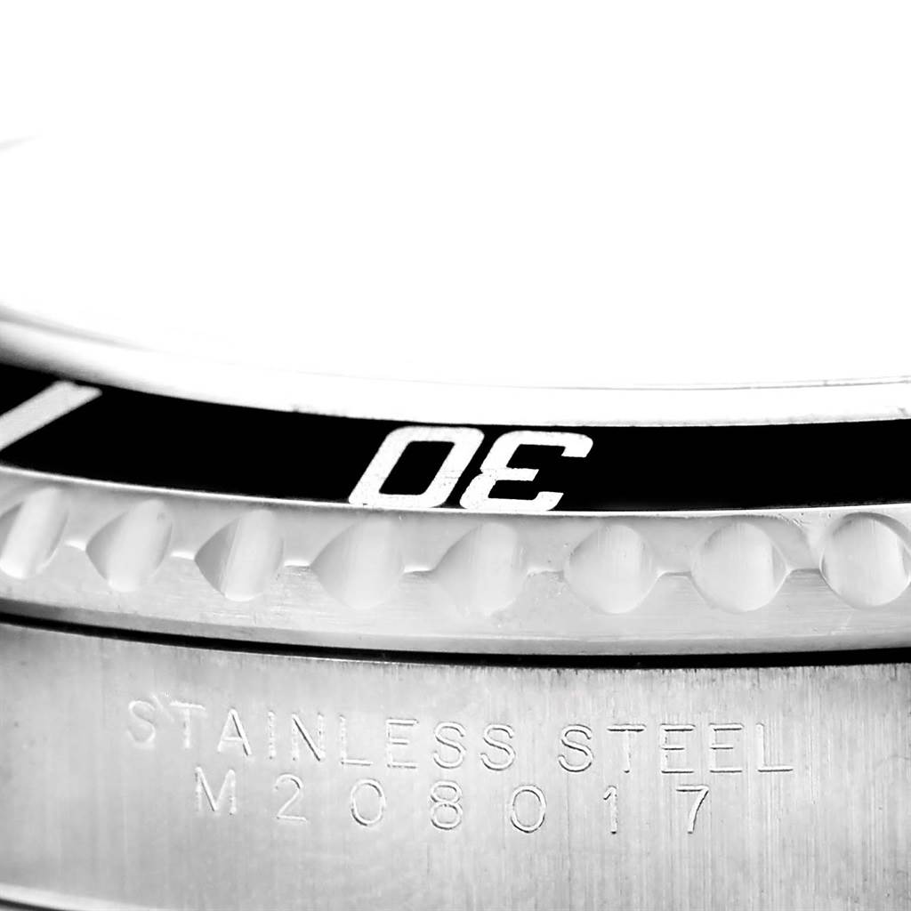 The image shows a close-up of the bezel and stainless steel case of a Rolex Submariner 14060 Men's Stainless Steel Black Dial 14060 Men's Stainless Steel Black Dial watch, including some serial numbers.