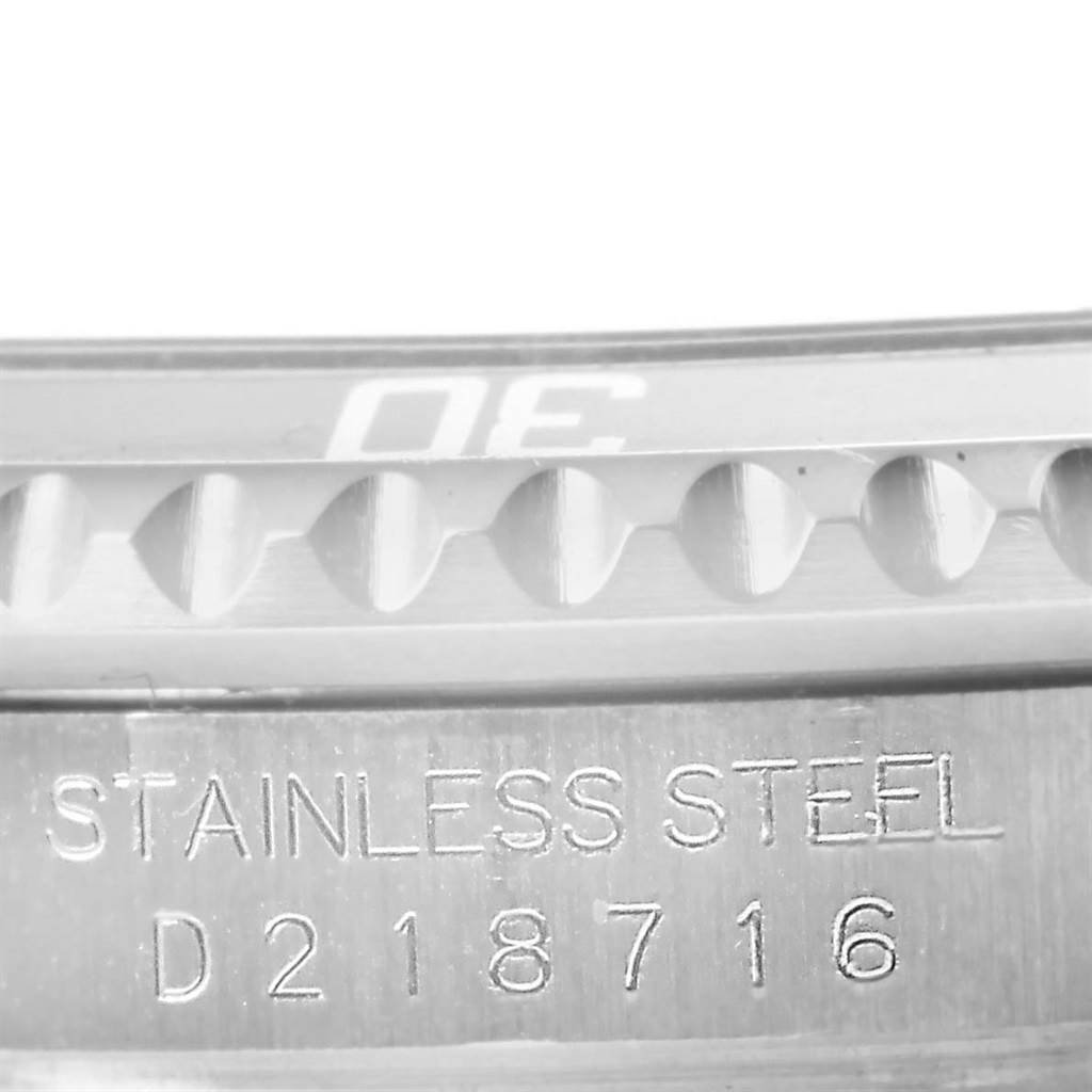 This image shows a close-up of the bezel and case with "Stainless Steel" engraving on a Rolex Submariner 16610 Men's Stainless Steel Black Dial 16610 Men's Stainless Steel Black Dial watch.