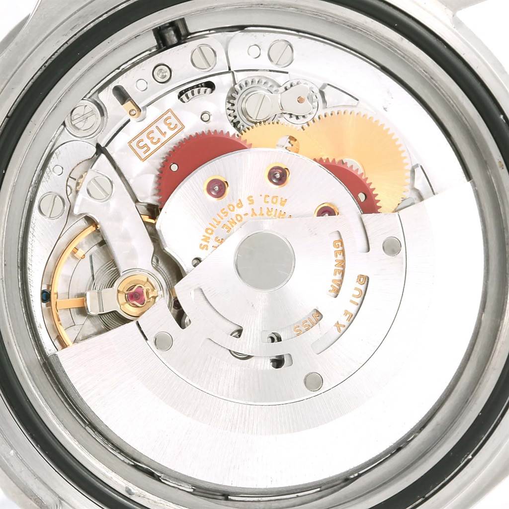 This is a close-up view of the movement mechanism inside a Rolex Submariner 16610 Men's Stainless Steel Black Dial 16610 Men's Stainless Steel Black Dial watch, showcasing gears and other internal components.