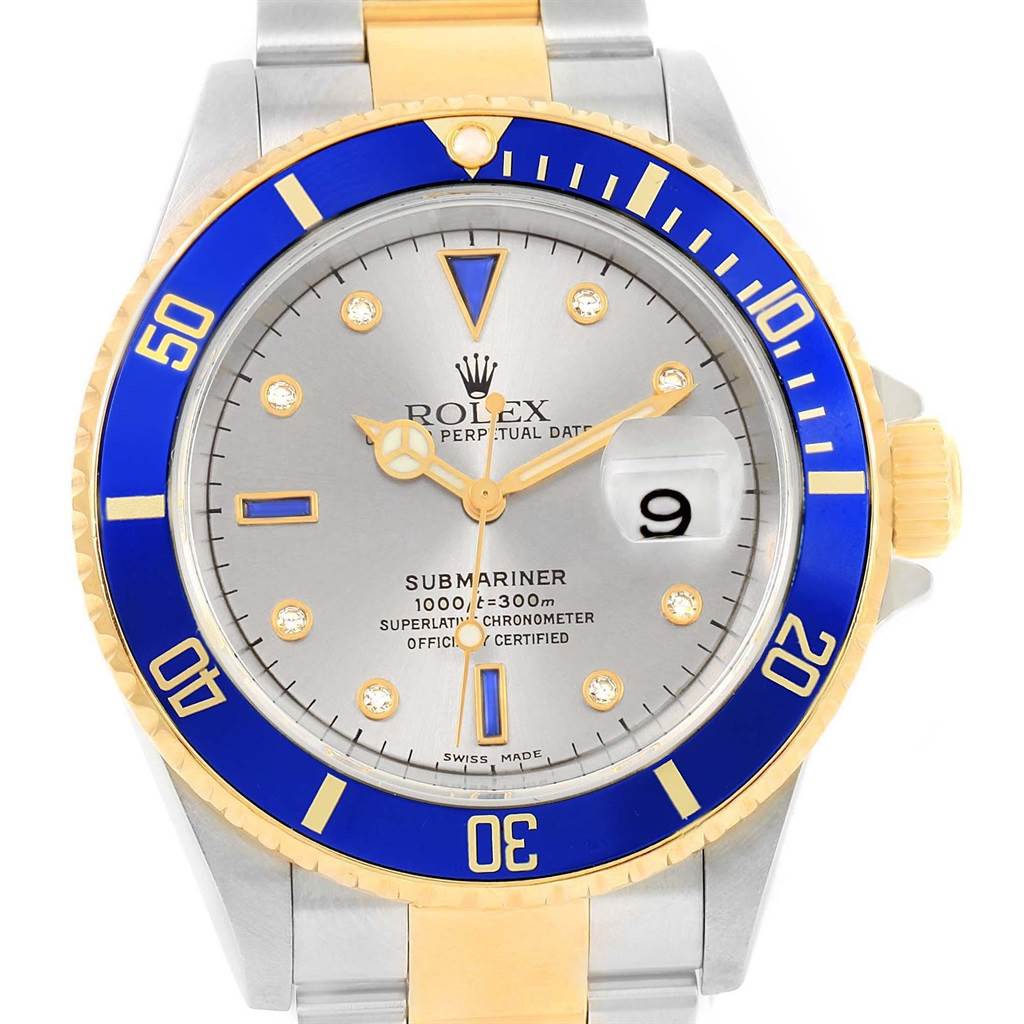The Rolex Submariner 16613 Men
s Steel and Gold (two tone) Grey Dial 16613 Men
s Steel and Gold (two tone) Grey Dial watch is shown from a front angle, displaying the face, bezel, and part of the wristband.