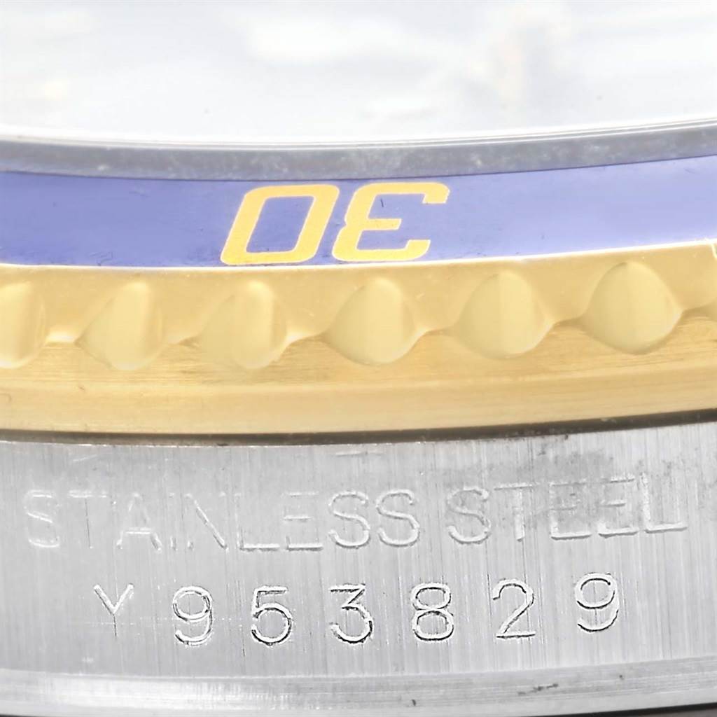 This image shows a close-up angle of the bezel and the etched serial number on the case of a Rolex Submariner 16613 Men
s Steel and Gold (two tone) Grey Dial 16613 Men
s Steel and Gold (two tone) Grey Dial watch.