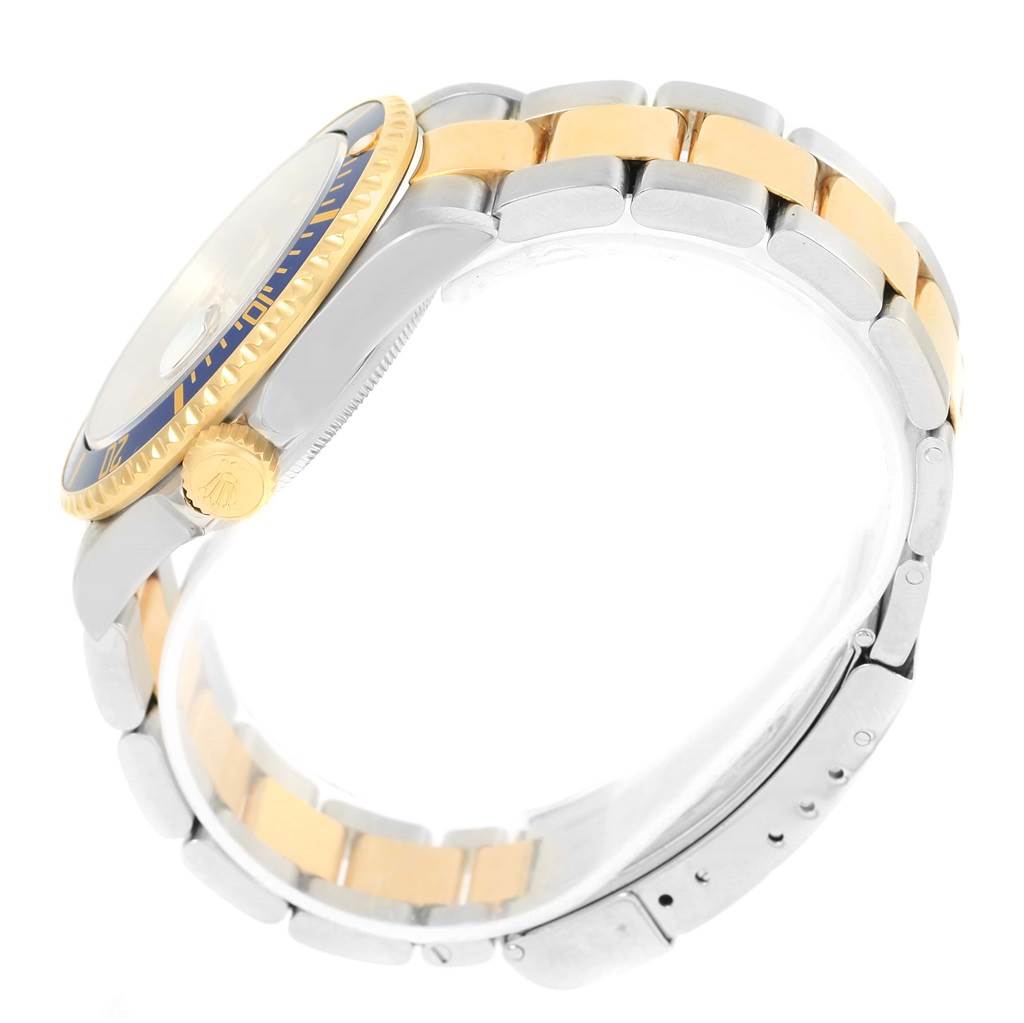 The image shows a side view of a Rolex Submariner 16613 Men
s Steel and Gold (two tone) Grey Dial 16613 Men
s Steel and Gold (two tone) Grey Dial watch, highlighting the crown, bezel, and two-tone bracelet.