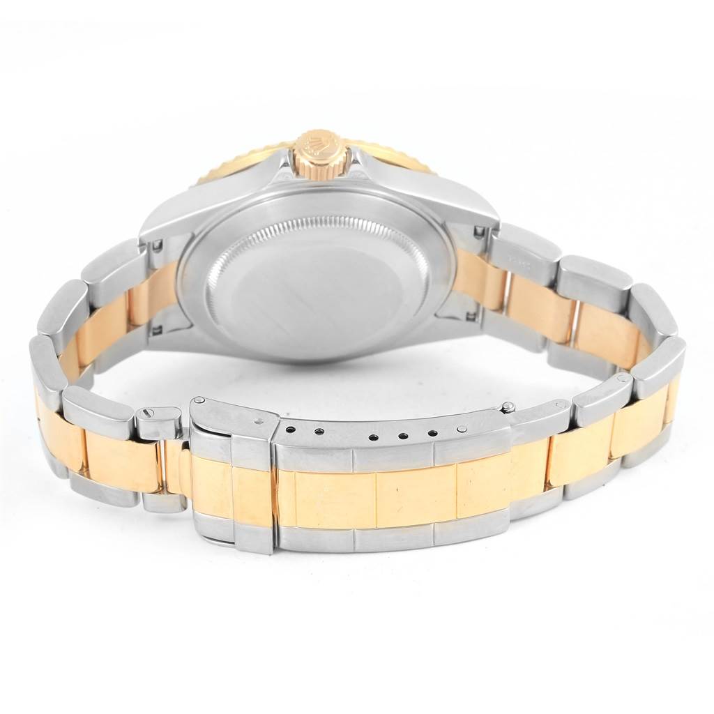 The image shows the back view of a Rolex Submariner 16613 Men
s Steel and Gold (two tone) Grey Dial 16613 Men
s Steel and Gold (two tone) Grey Dial watch, highlighting its two-tone bracelet and clasp.