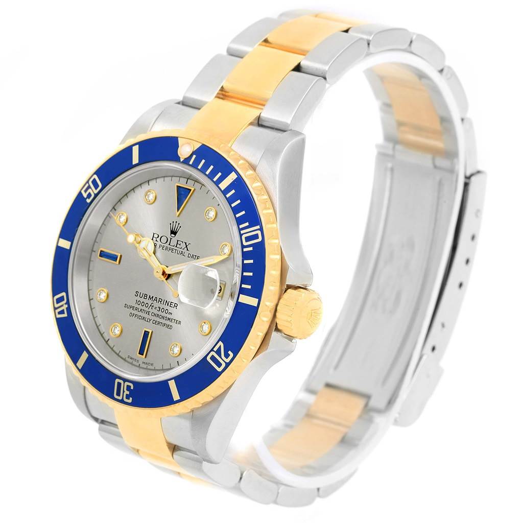 The image shows a side angle of a Rolex Submariner 16613 Men
s Steel and Gold (two tone) Grey Dial 16613 Men
s Steel and Gold (two tone) Grey Dial watch, focusing on its bezel, dial, and bracelet.