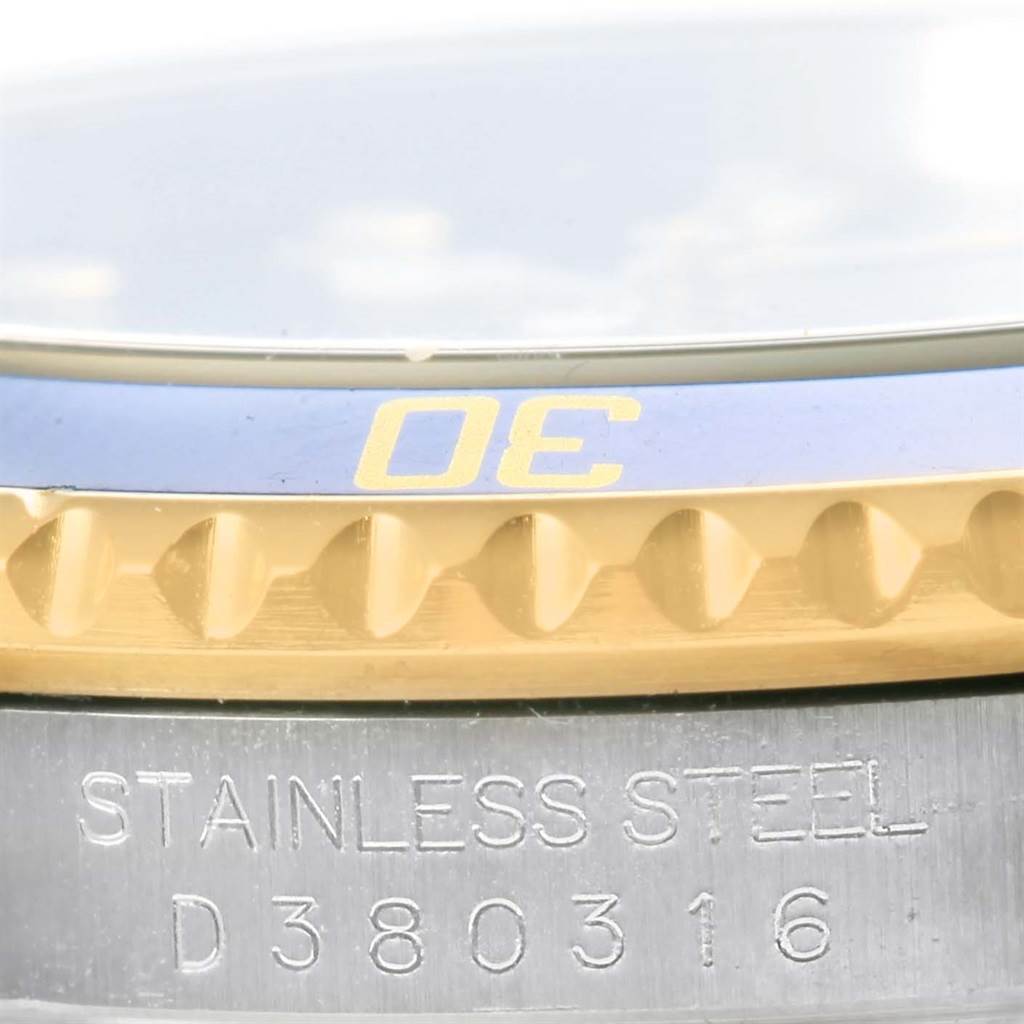 This image shows a close-up of the bezel and part of the case back of a Rolex Submariner 16613 Men's Steel and Gold (two tone) Blue Dial 16613 Men's Steel and Gold (two tone) Blue Dial watch.