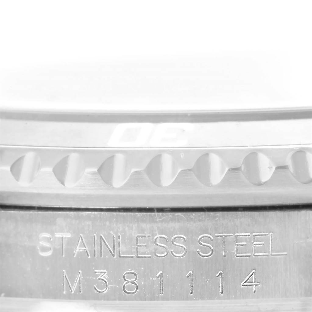 The close-up image shows the side view of a stainless steel Rolex Submariner 16610 Men's Stainless Steel Black Dial 16610 Men's Stainless Steel Black Dial watch bezel and the engraved serial number.