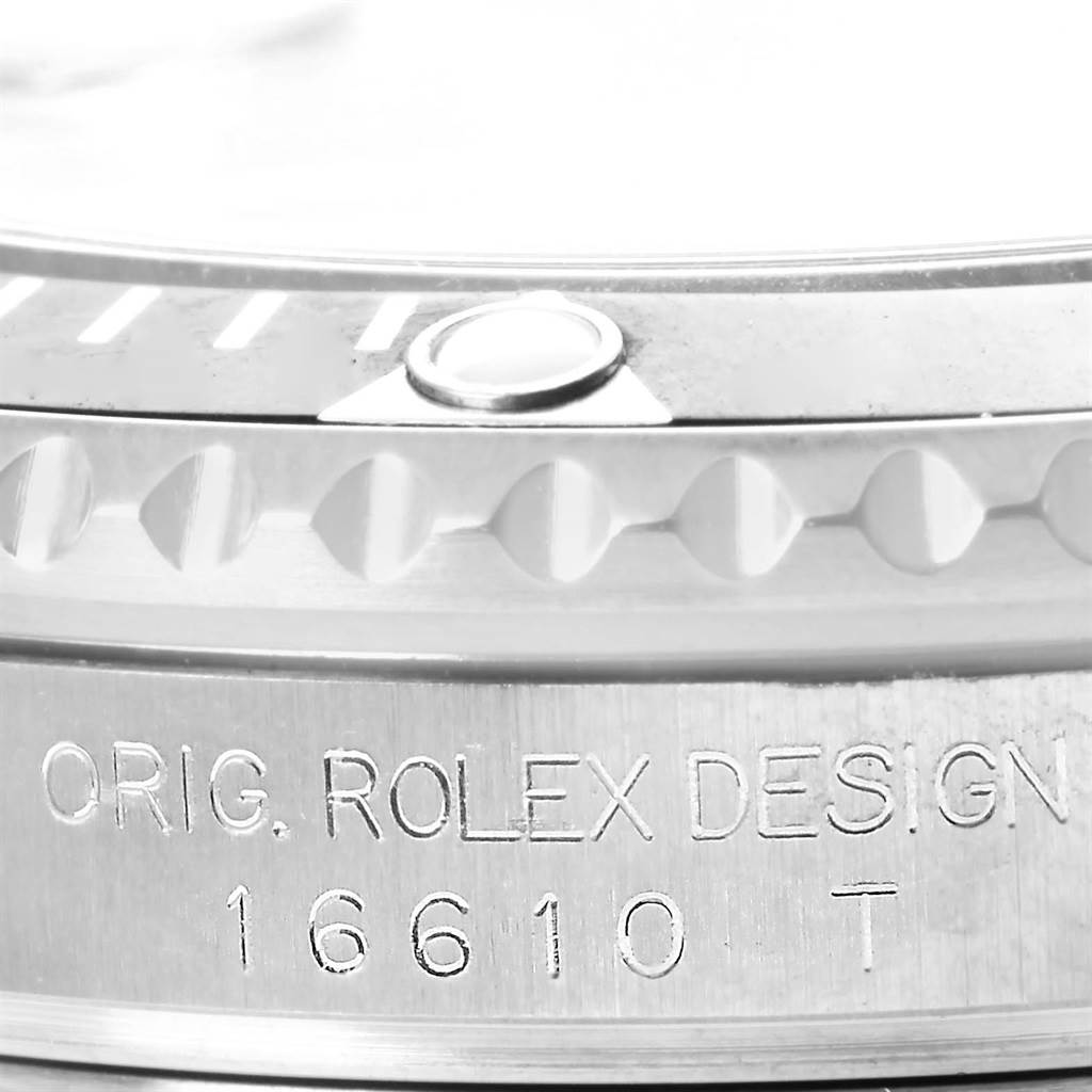 The image shows a close-up of the side of a Rolex Submariner 16610 Men's Stainless Steel Black Dial 16610 Men's Stainless Steel Black Dial, highlighting the bezel and engraved model number 16610T.
