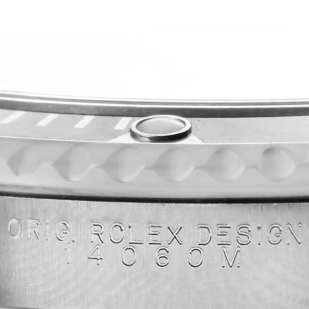 The close-up image of this Rolex Submariner 14060 Men's Stainless Steel Black Dial 14060 Men's Stainless Steel Black Dial watch shows the bezel and engraved text on the case.