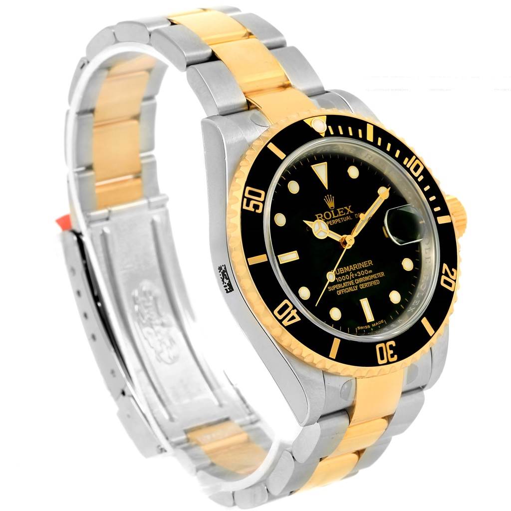 The image shows a Rolex Submariner 16613 Men
s Steel and Gold (two tone) Black Dial 16613 Men
s Steel and Gold (two tone) Black Dial watch at an angle highlighting its two-tone bracelet and black dial.