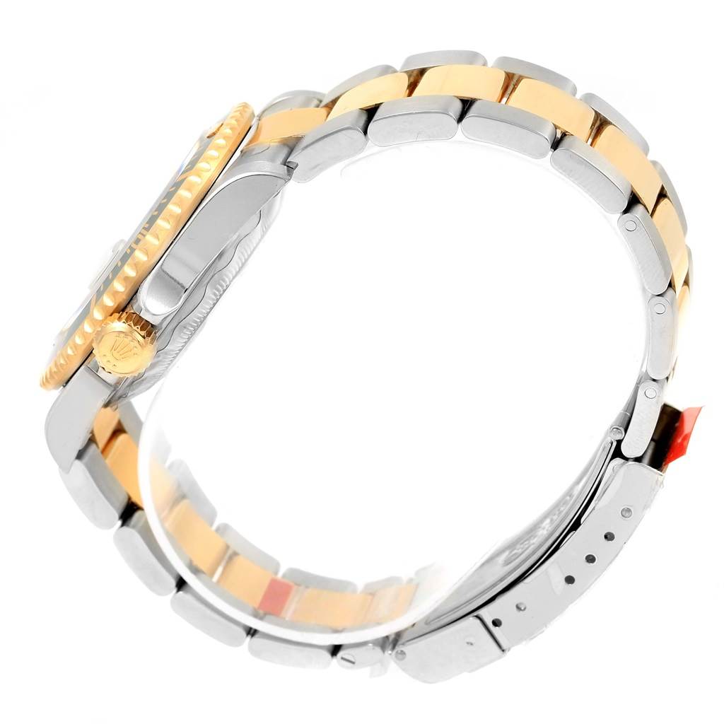 This image shows a side view of a Rolex Submariner 16613 Men
s Steel and Gold (two tone) Black Dial 16613 Men
s Steel and Gold (two tone) Black Dial watch, showcasing its crown, bezel, and two-tone bracelet.