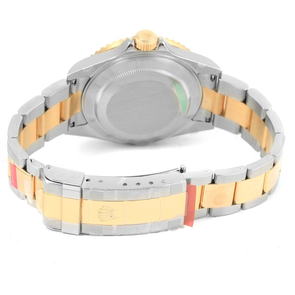 This image shows the back view of a Rolex Submariner 16613 Men
s Steel and Gold (two tone) Black Dial 16613 Men
s Steel and Gold (two tone) Black Dial watch, focusing on its gold and silver metal bracelet and case back.