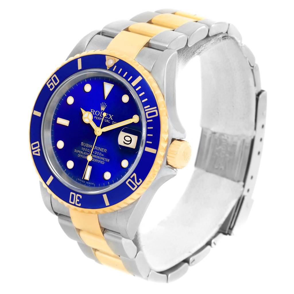 The Rolex Submariner 16613 Men
s Steel and Gold (two tone) Blue Dial 16613 Men
s Steel and Gold (two tone) Blue Dial watch is shown from an angled view, highlighting its blue dial, two-tone bracelet, and date display.