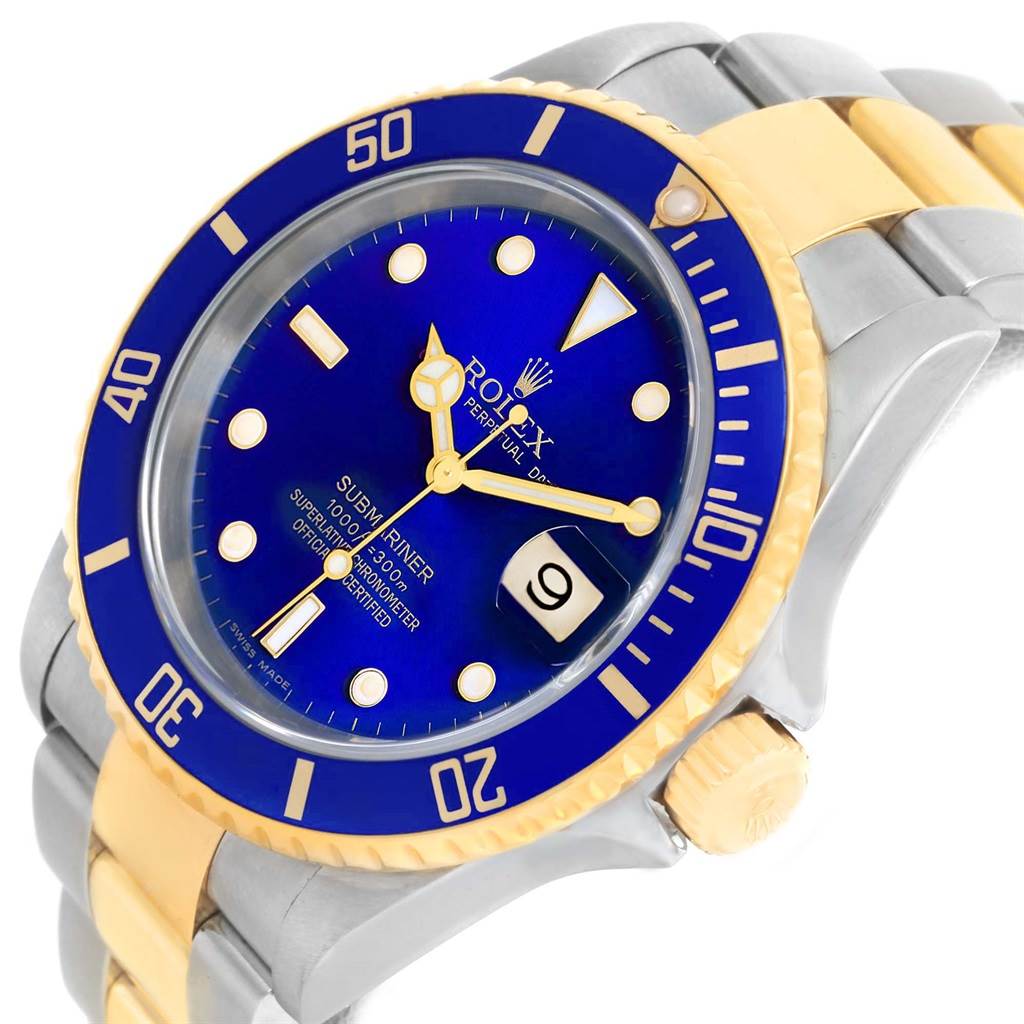 The image shows a close-up angled view of a Rolex Submariner 16613 Men
s Steel and Gold (two tone) Blue Dial 16613 Men
s Steel and Gold (two tone) Blue Dial watch, focusing on the dial, bezel, and part of the bracelet.