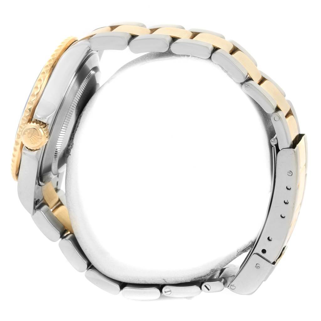 The image shows the side view of a Rolex Submariner 16613 Men
s Steel and Gold (two tone) Blue Dial 16613 Men
s Steel and Gold (two tone) Blue Dial watch, highlighting the crown, case, and bracelet with a two-tone color scheme.