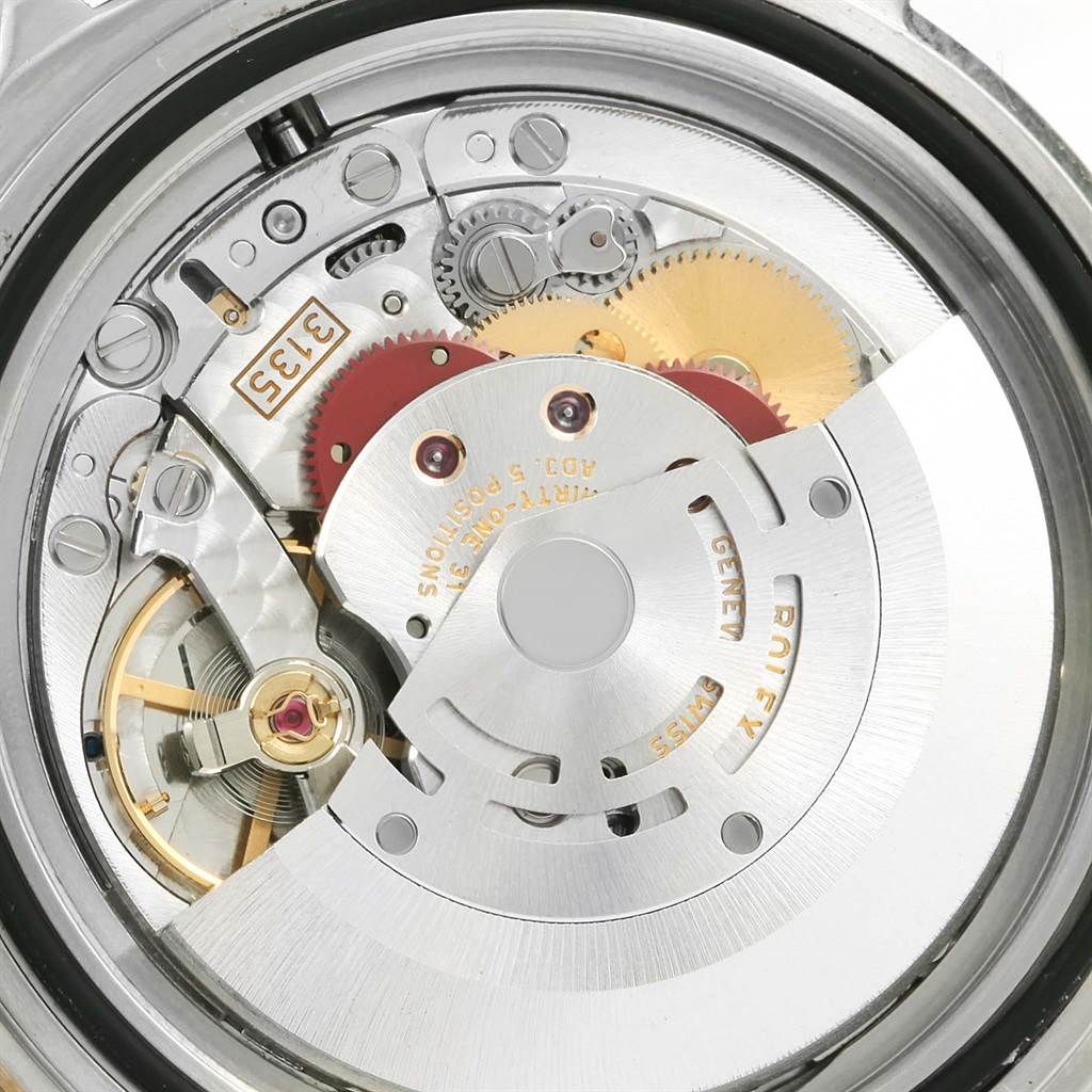 This image shows the internal movement components of a Rolex Submariner 16613 Men
s Steel and Gold (two tone) Blue Dial 16613 Men
s Steel and Gold (two tone) Blue Dial watch from a close-up, back view angle.