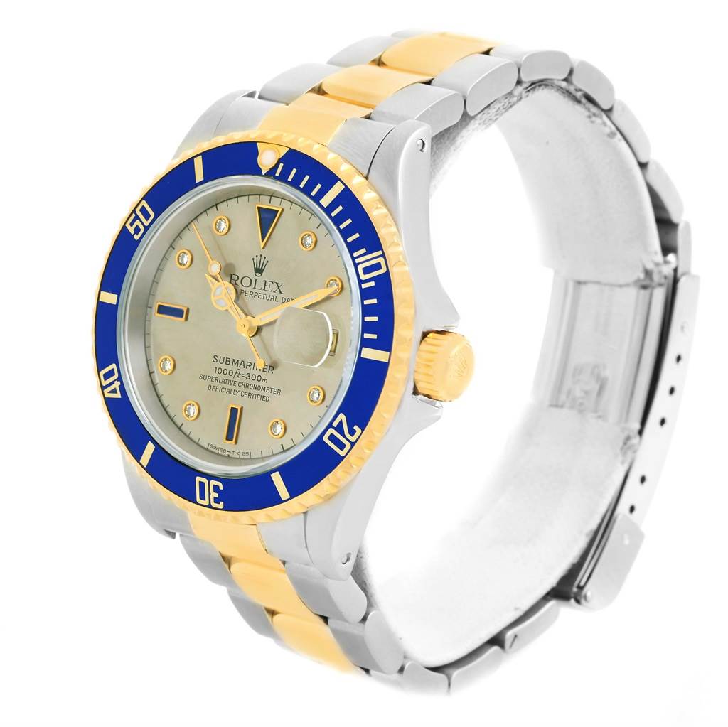 The image shows a Rolex Submariner 16613 Men's Steel and Gold (two tone) Grey Dial 16613 Men's Steel and Gold (two tone) Grey Dial watch angled from the front-left, showcasing its bezel, dial, and part of the bracelet.