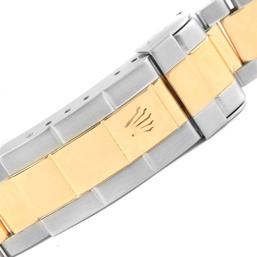The image shows a close-up of the bracelet and clasp of a Rolex Submariner 16613 Men
s Steel and Gold (two tone) Black Dial 16613 Men
s Steel and Gold (two tone) Black Dial watch, featuring a two-tone metal design.