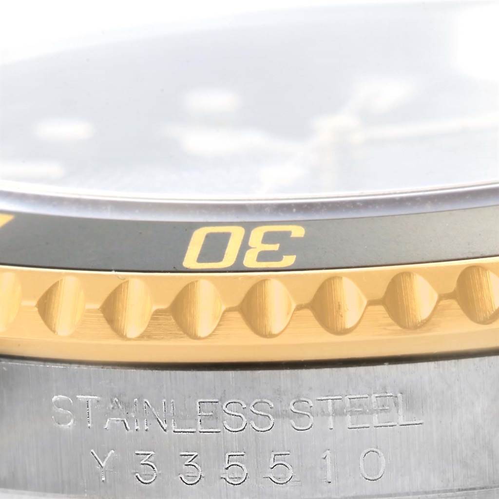This close-up image shows the bezel and part of the case of a Rolex Submariner 16613 Men
s Steel and Gold (two tone) Black Dial 16613 Men
s Steel and Gold (two tone) Black Dial watch, highlighting the 30-minute mark and serial number.