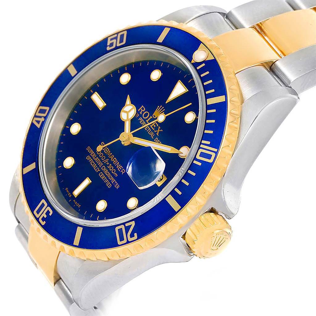This Rolex Submariner 16613 Men's Steel and Gold (two tone) Blue Dial 16613 Men's Steel and Gold (two tone) Blue Dial watch is shown at an angle highlighting its blue and gold bezel, dial, and part of the bracelet.