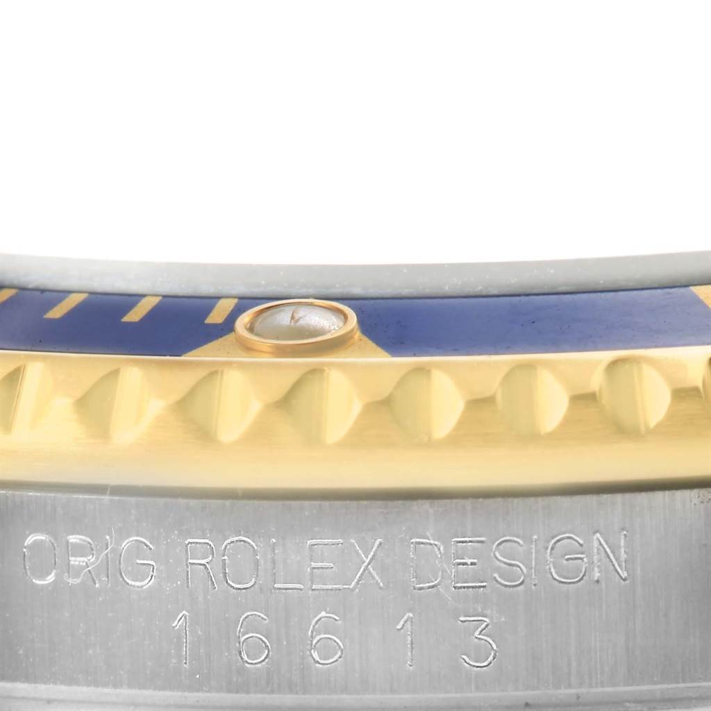 This close-up image shows the bezel edge and case side with engraved details of a Rolex Submariner 16613 Men's Steel and Gold (two tone) Champagne Dial 16613 Men's Steel and Gold (two tone) Champagne Dial model 16613.