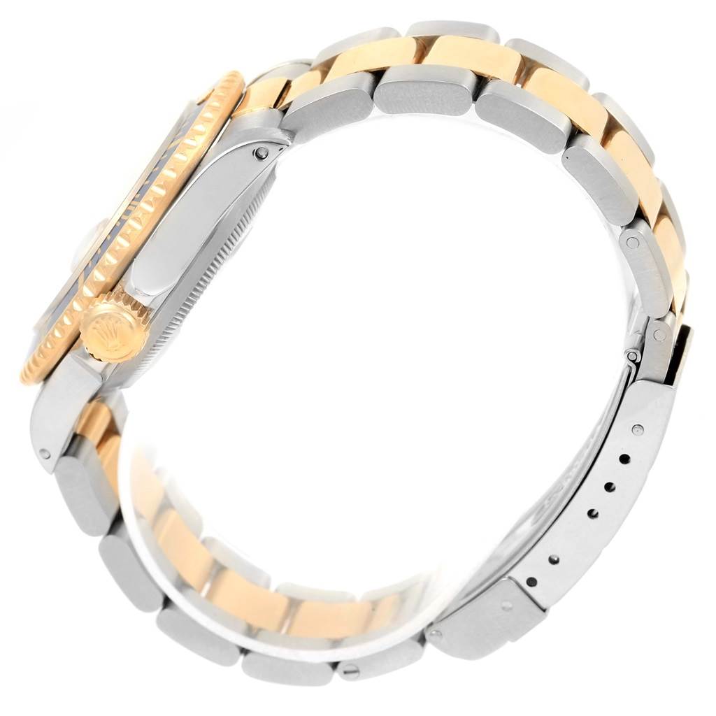 This image shows the side view of a Rolex Submariner 16613 Men's Steel and Gold (two tone) Champagne Dial 16613 Men's Steel and Gold (two tone) Champagne Dial watch, highlighting its case, crown, and two-tone metal bracelet.