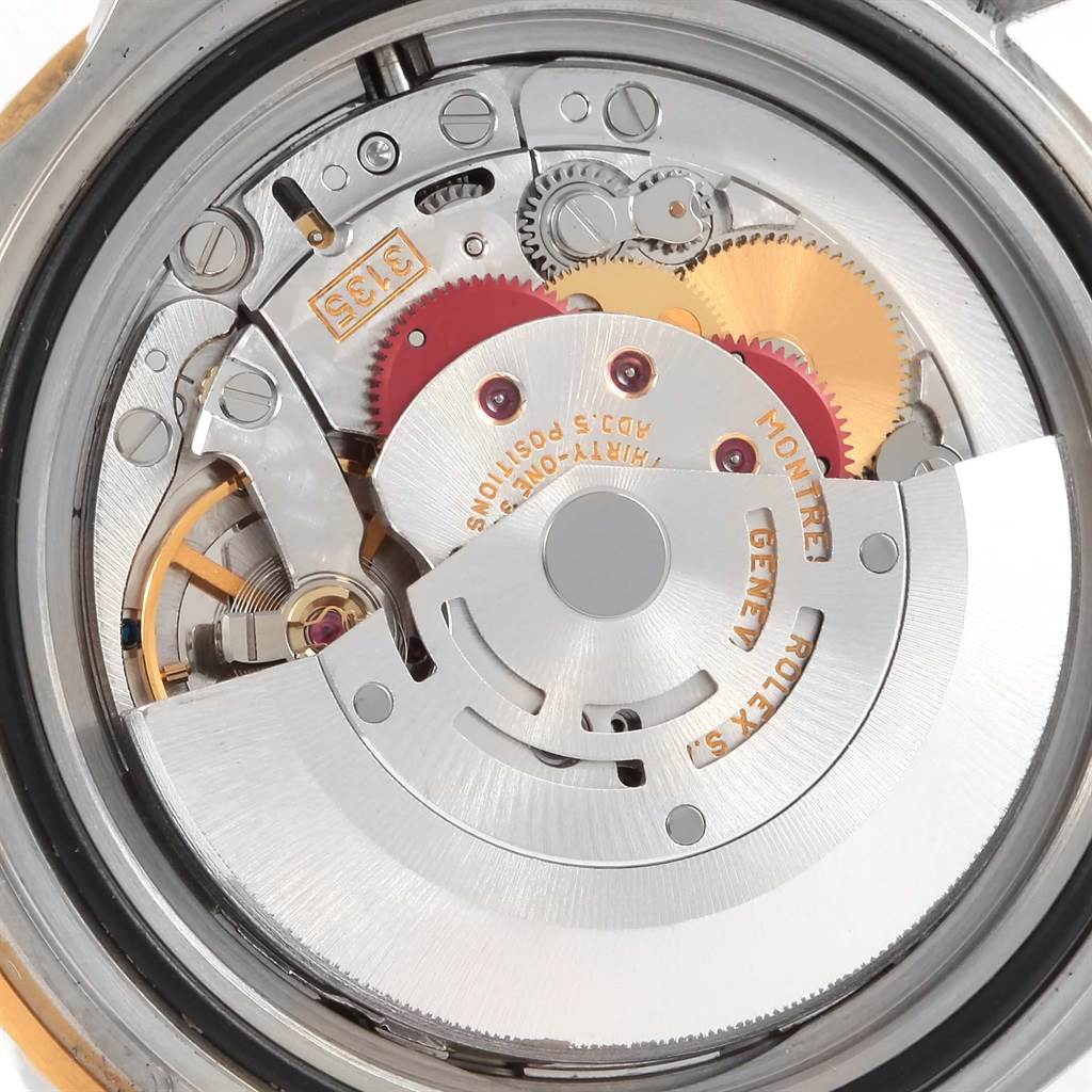 The image shows a close-up view of the intricate movement mechanism of a Rolex Submariner 16613 Men's Steel and Gold (two tone) Blue Dial 16613 Men's Steel and Gold (two tone) Blue Dial watch.