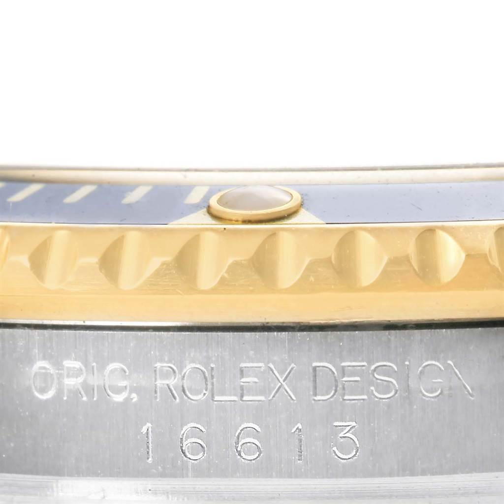 This close-up image shows the bezel with gold detailing and the engraved model number "16613" of the Rolex Submariner 16613 Men's Steel and Gold (two tone) Blue Dial 16613 Men's Steel and Gold (two tone) Blue Dial watch.