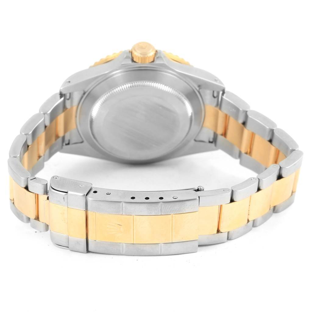 The image shows the back and clasp of a Rolex Submariner 16613 Men's Steel and Gold (two tone) Blue Dial 16613 Men's Steel and Gold (two tone) Blue Dial watch, highlighting its two-tone metal bracelet.