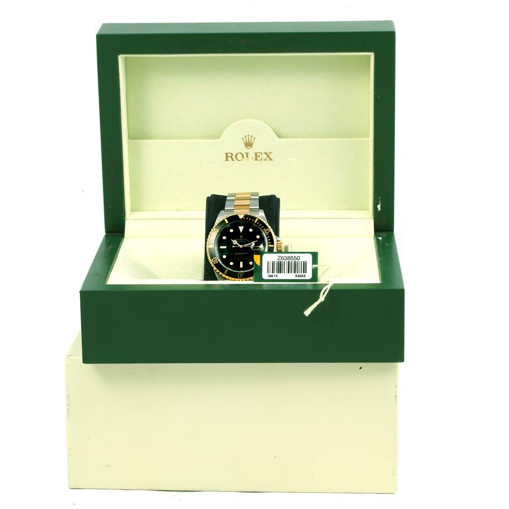 The image shows a Rolex Submariner 16613 Men's Steel and Gold (two tone) Black Dial 16613 Men's Steel and Gold (two tone) Black Dial watch in its box, viewed from the front, displaying the watch face and bracelet.