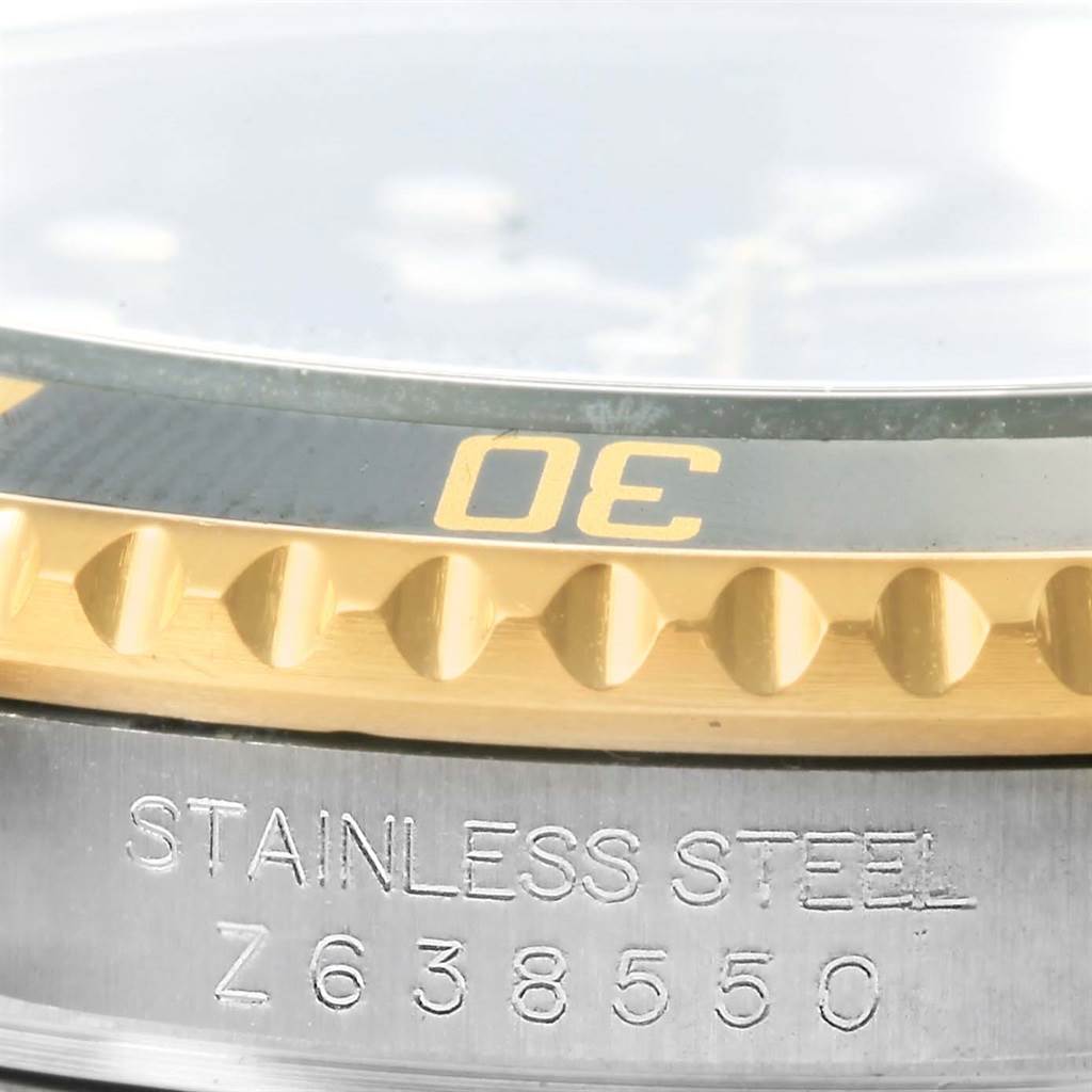 This image shows a close-up of the bezel and case edge of a Rolex Submariner 16613 Men's Steel and Gold (two tone) Black Dial 16613 Men's Steel and Gold (two tone) Black Dial watch.