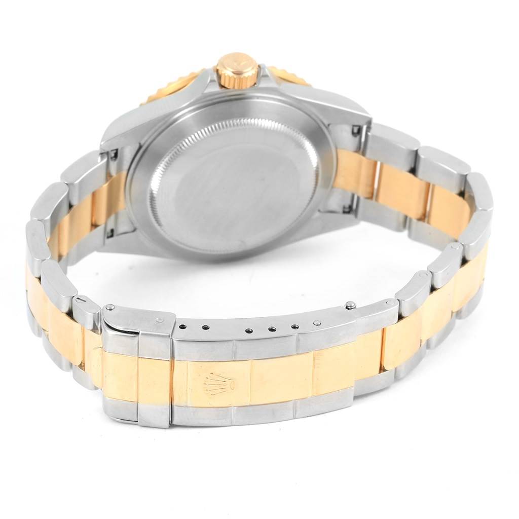 The image shows the back and bracelet of a Rolex Submariner 16613 Men's Steel and Gold (two tone) Black Dial 16613 Men's Steel and Gold (two tone) Black Dial, highlighting its two-tone metal design and clasp.