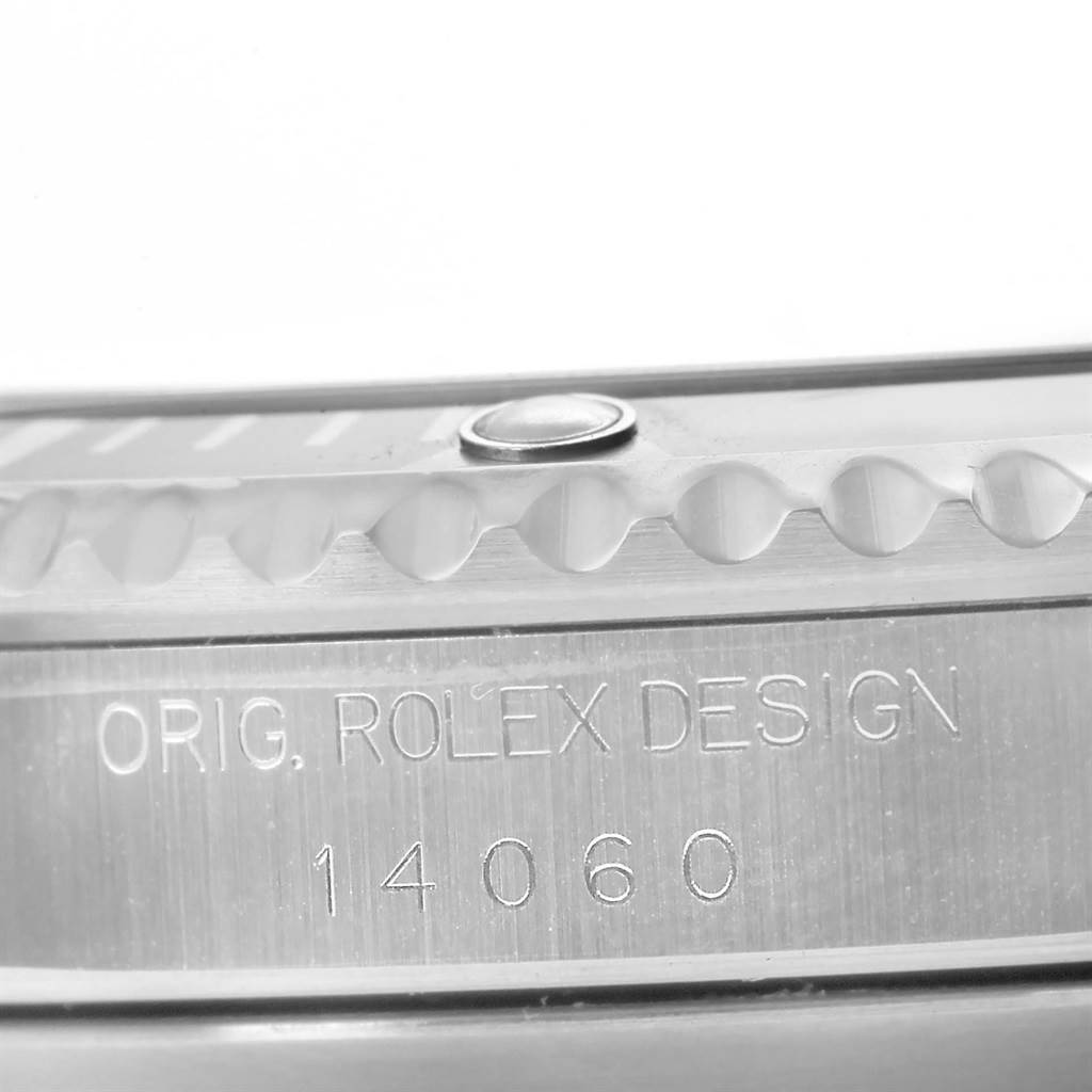 The image shows a close-up of the side engraving on a Rolex Submariner 14060 Men's Stainless Steel Black Dial 14060 Men's Stainless Steel Black Dial, featuring the model number and "ORIG. ROLEX DESIGN."