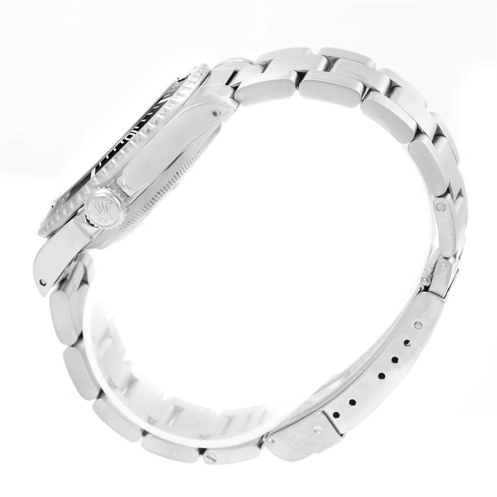 This side-view image of the Rolex Submariner 14060 Men's Stainless Steel Black Dial 14060 Men's Stainless Steel Black Dial watch showcases the case, crown, bezel, and bracelet links.