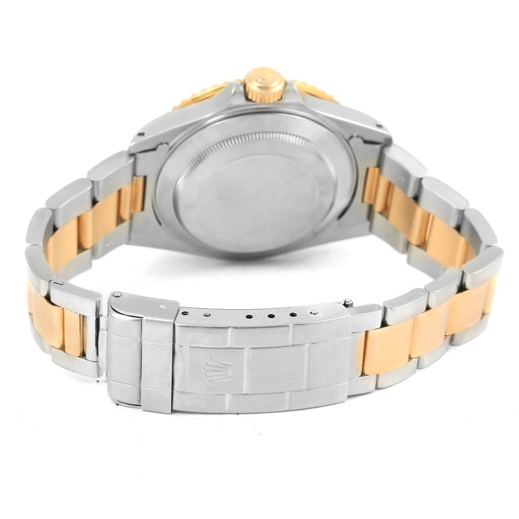 The image shows the back of a Rolex Submariner 16613 Men's Steel and Gold (two tone) Blue Dial 16613 Men's Steel and Gold (two tone) Blue Dial watch, focusing on the case back, crown, and two-tone bracelet.