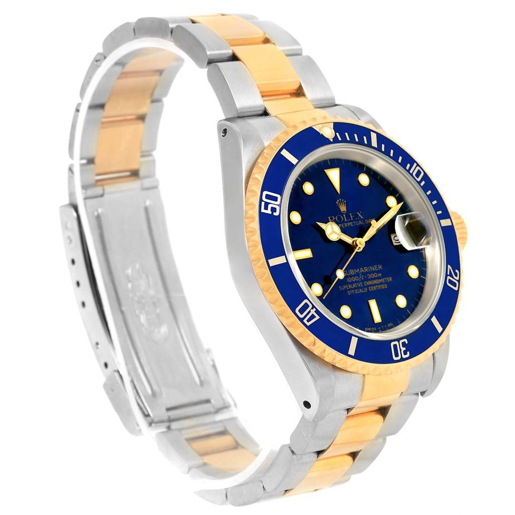 This image shows a Rolex Submariner 16613 Men's Steel and Gold (two tone) Blue Dial 16613 Men's Steel and Gold (two tone) Blue Dial watch at an oblique angle, highlighting its blue dial, bezel, and two-tone metal bracelet.