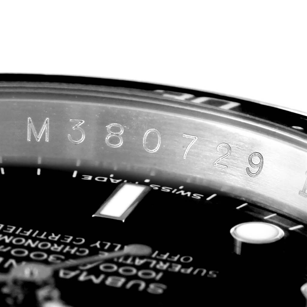 The image shows a close-up of the bezel and a portion of the dial on the Rolex Submariner 16610 Men
s Stainless Steel Black Dial 16610 Men
s Stainless Steel Black Dial watch, highlighting the serial number.