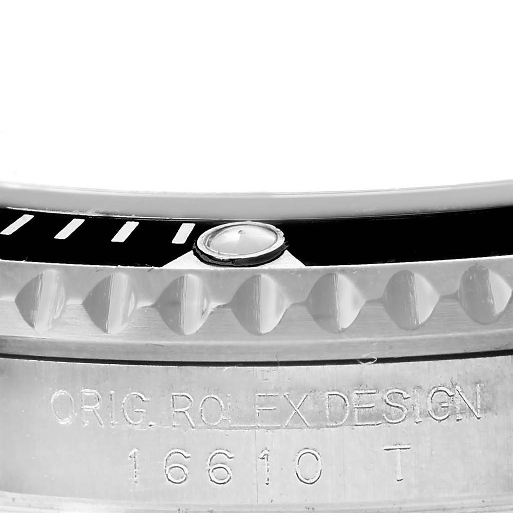 The image shows a close-up of the bezel and serial number engraving on a Rolex Submariner 16610 Men's Stainless Steel Black Dial 16610 Men's Stainless Steel Black Dial watch.