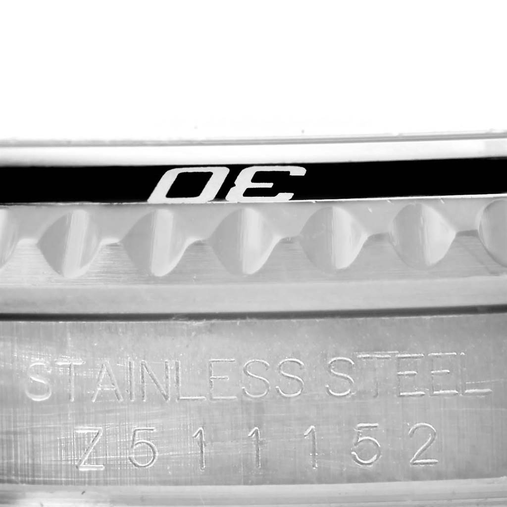 This is a close-up of the bezel and case side of a Rolex Submariner 16610 Men's Stainless Steel Black Dial 16610 Men's Stainless Steel Black Dial, showing the "40" on the bezel and the stainless steel information with serial number.