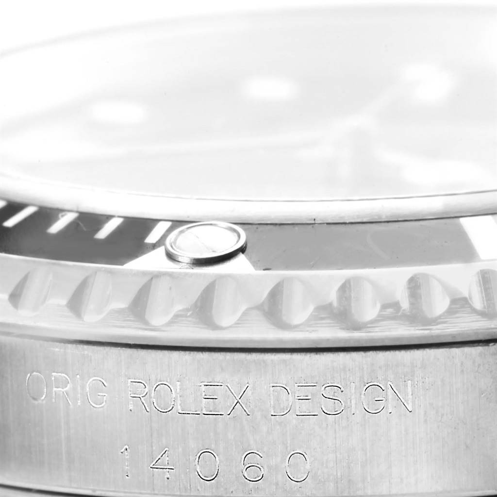 The image shows a close-up of the Rolex Submariner 14060 Men's Stainless Steel Black Dial 14060 Men's Stainless Steel Black Dial bezel and case edge with the model number 14060 engraved.